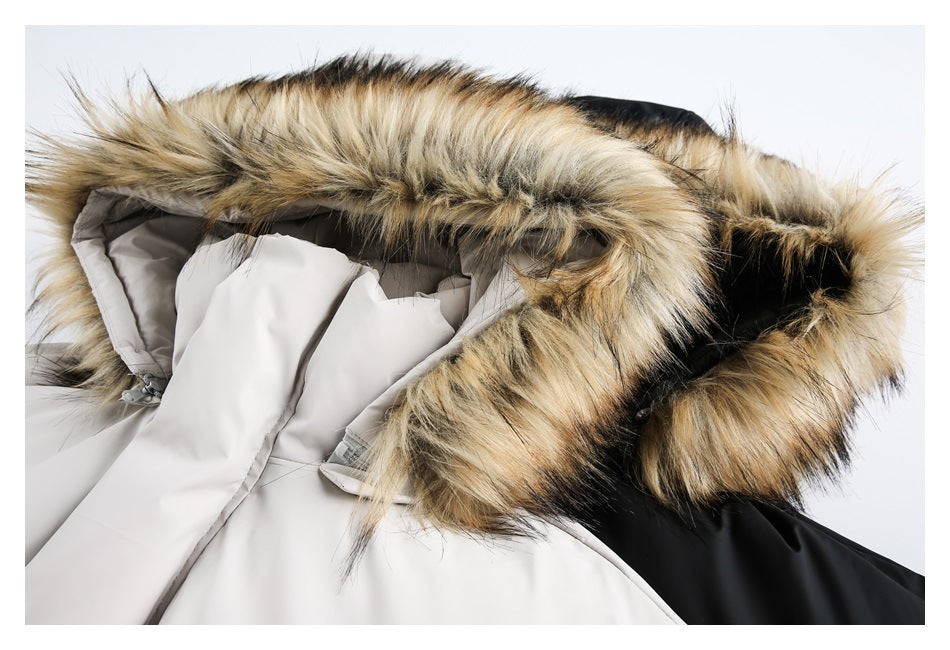Close-up of the tan and black faux-fur hood trim on a light gray puffer jacket, with part of a black jacket beside it.