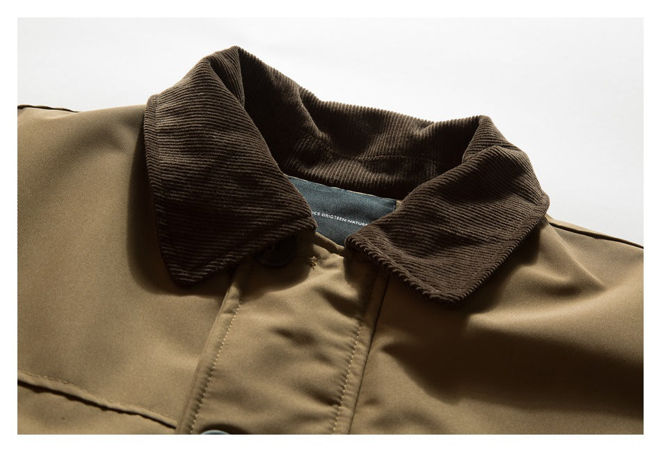 Close-up of a tan jacket's dark brown ribbed collar and upper button placket.
