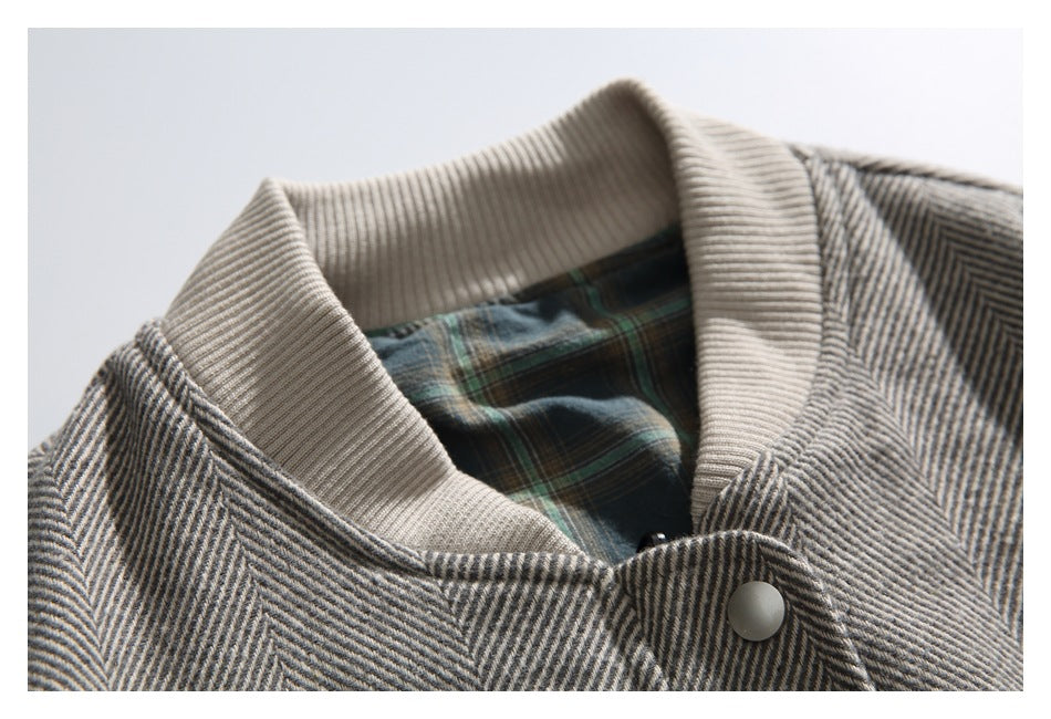 Close-up of the jacket's beige ribbed collar and green-and-blue plaid lining.