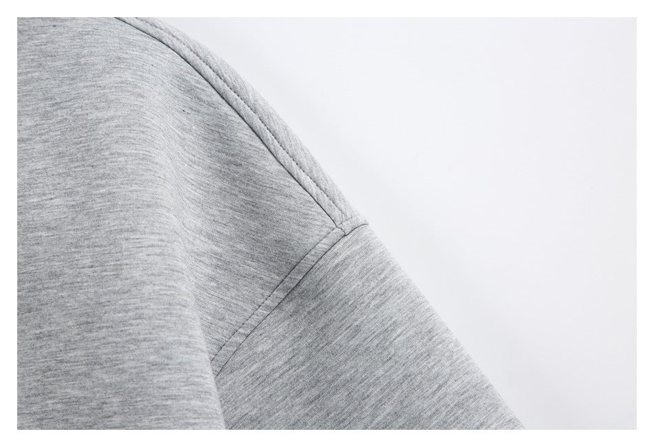 Close-up of a light gray jacket sleeve and shoulder seam.