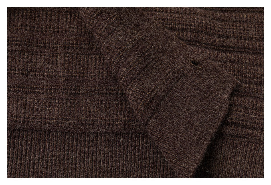 Close-up of a patch pocket on a dark brown ribbed knit garment.