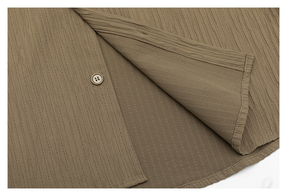 Taupe shirt opened to show overlapping panels, a button, striped texture, and finished edges.