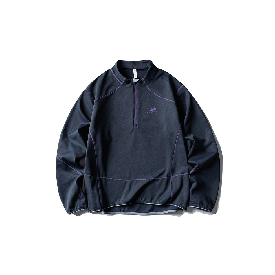 Navy blue half-zip pullover flat lay with purple contrast stitching and zipper
