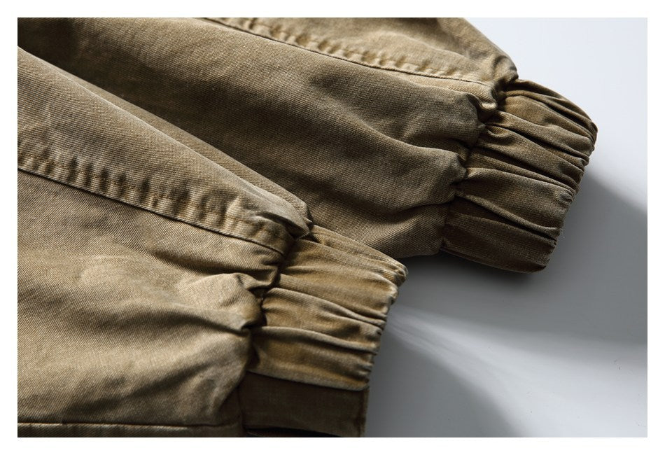Close-up of khaki-brown garment sleeves with gathered, elasticized cuffs.