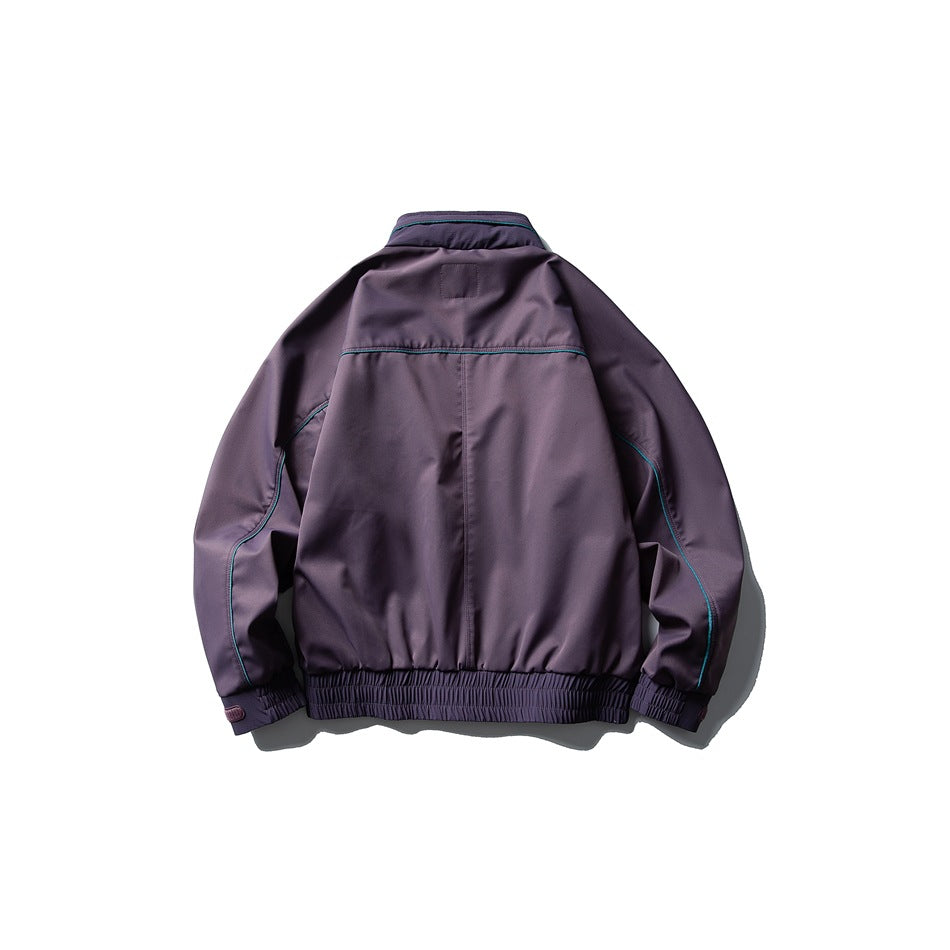 Back view of a dark purple jacket with teal piping, an elastic hem, and adjustable cuffs.