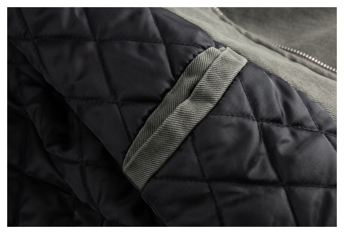 Close-up of the jacket's black quilted lining and charcoal gray cuff trim.