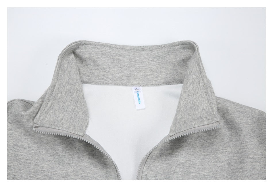 Close-up of a heather gray jacket's inside collar, zipper, and small sewn-in neck label.