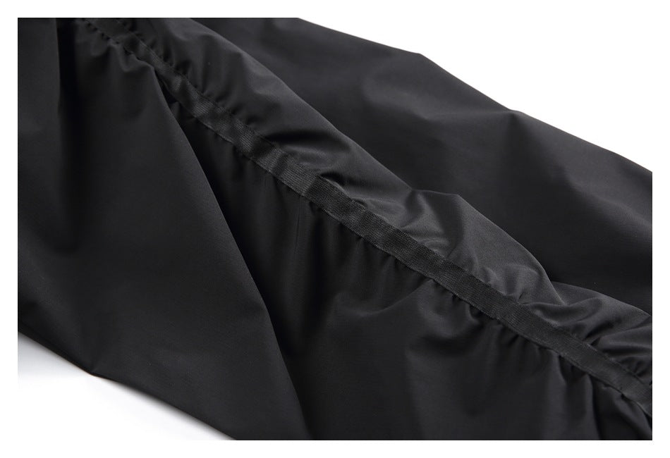 Close-up of black garment fabric with a reinforced seam and stitching.