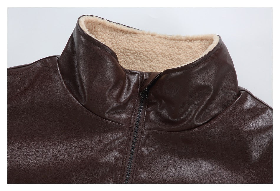 Close-up of a dark brown jacket's raised collar, cream textured lining, and front zipper.