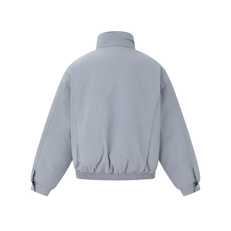 Back view of a light gray-blue jacket with a high collar, long sleeves, and an elasticized hem.