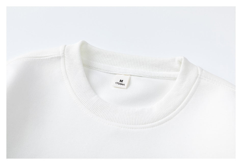 Close-up of a white sweatshirt's ribbed crewneck and inner size label marked M, 170/84A.