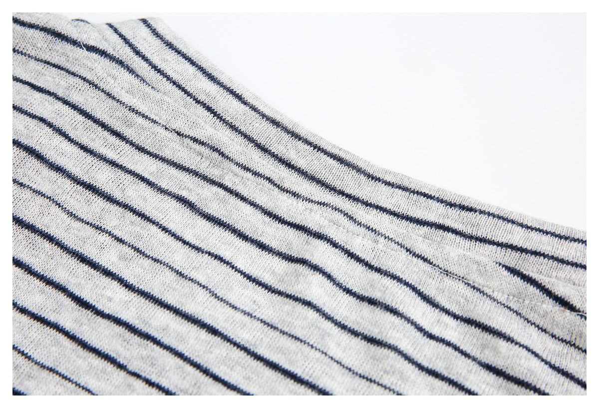 Close-up of light gray knit fabric with thin navy stripes and a stitched edge.