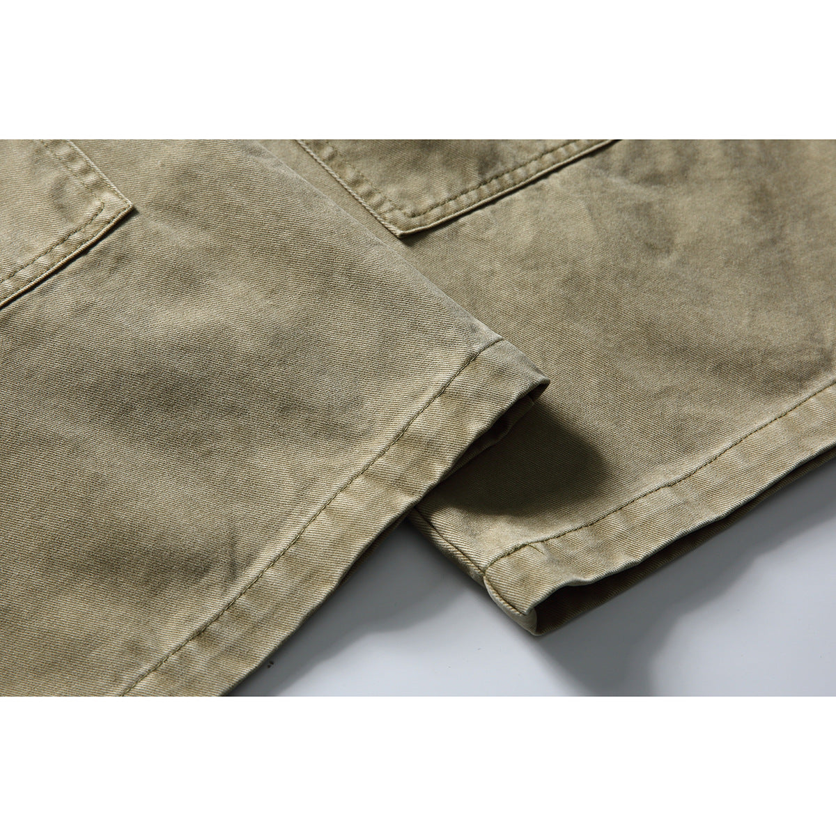 Close-up of khaki pants showing the straight legs and stitched hems.