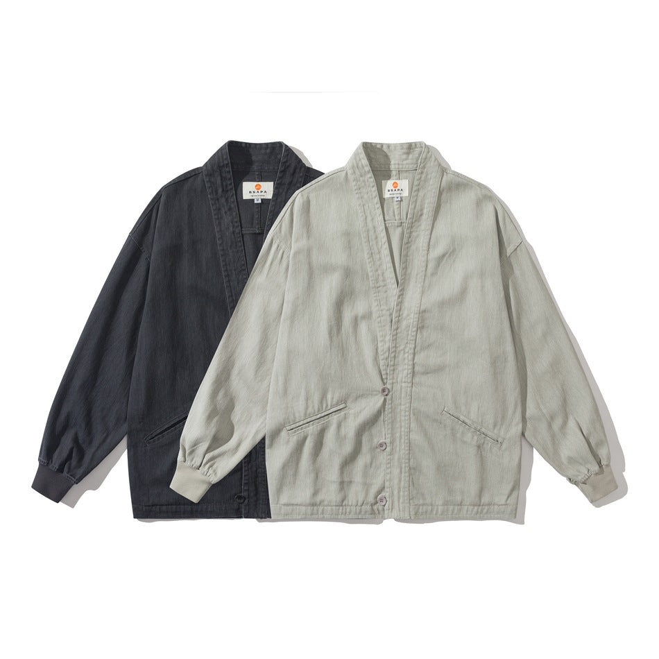 Two front-view jackets with band collars, buttons, pockets and ribbed cuffs, in charcoal and light gray-green.