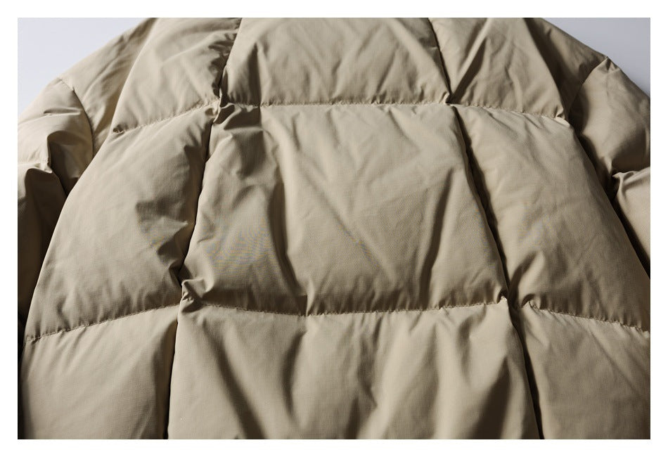 Close-up of a beige padded jacket with wide horizontal quilted panels.