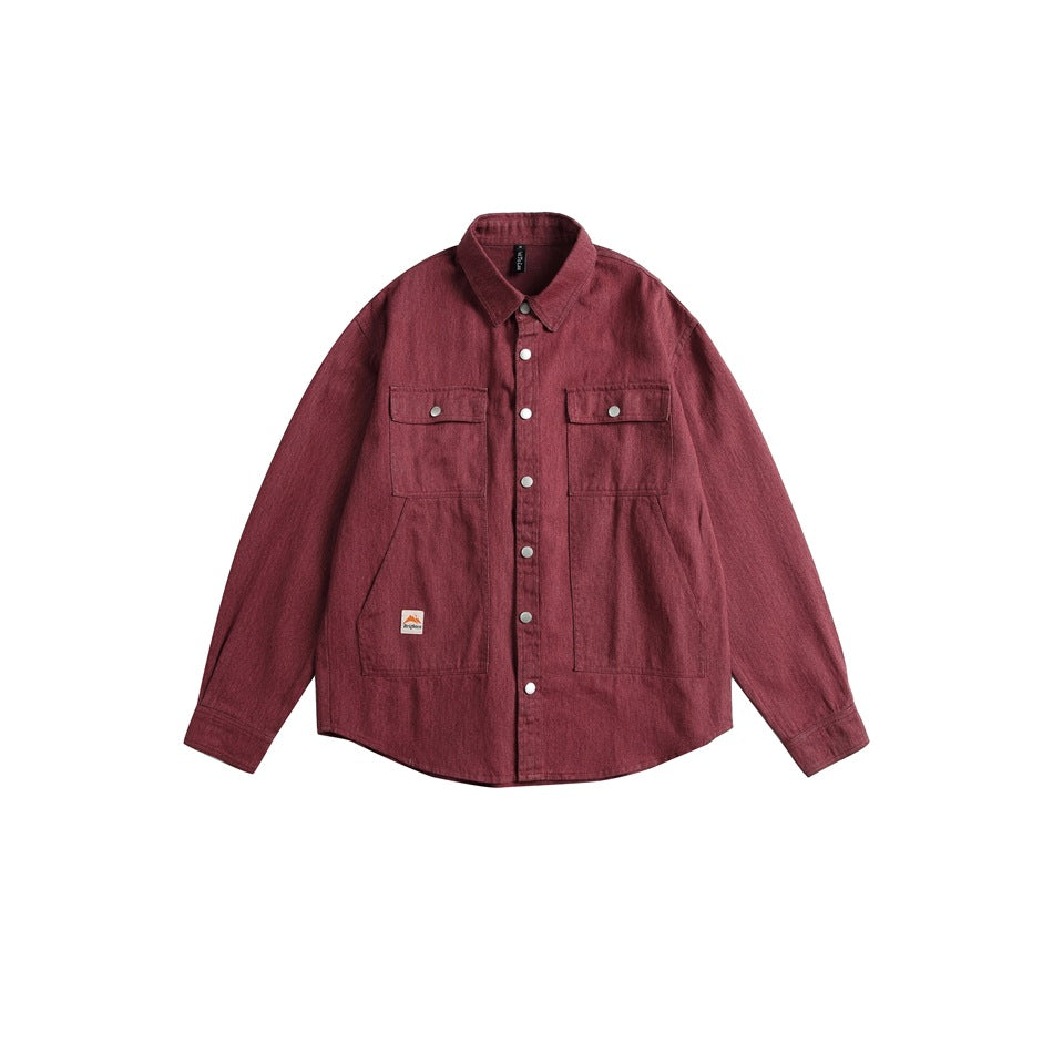 Front view of a burgundy long-sleeved overshirt with snap buttons, two chest flap pockets and two lower pockets.