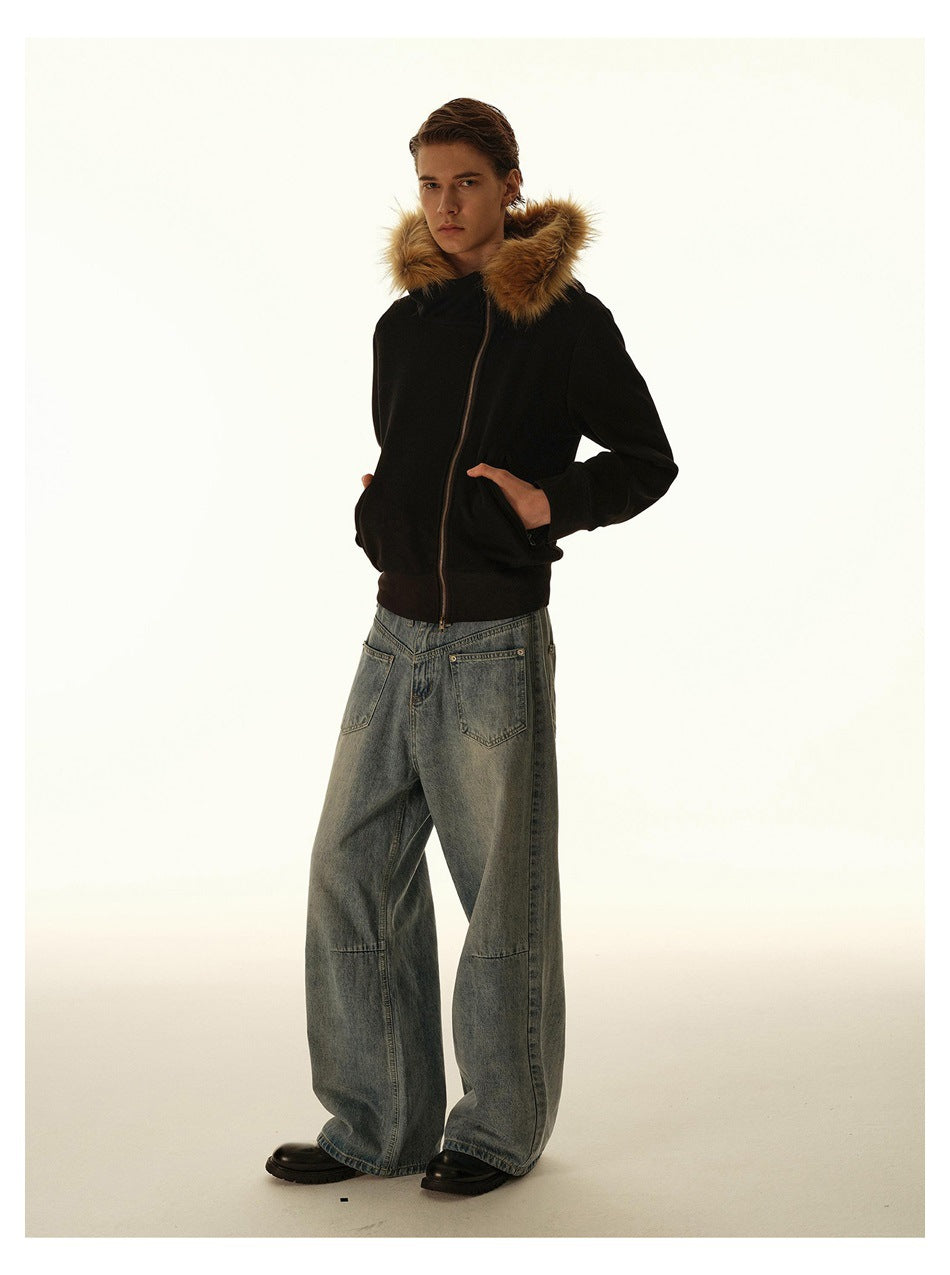 Full-length side view of a model in a black hooded zip jacket with fur-style trim, wide-leg jeans and black boots