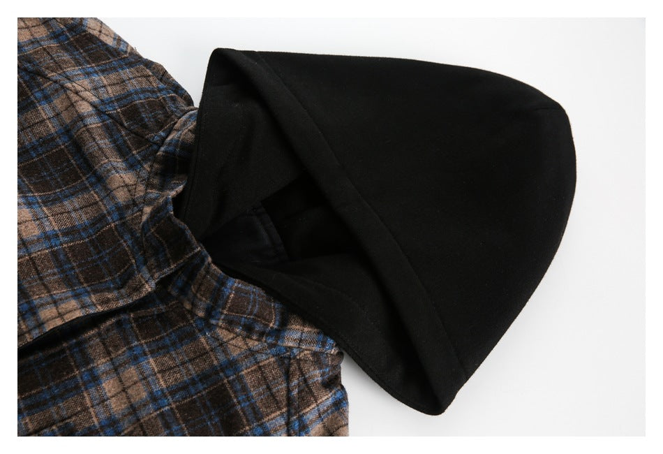 Side view of the black hood beside the jacket's brown and blue plaid body fabric.