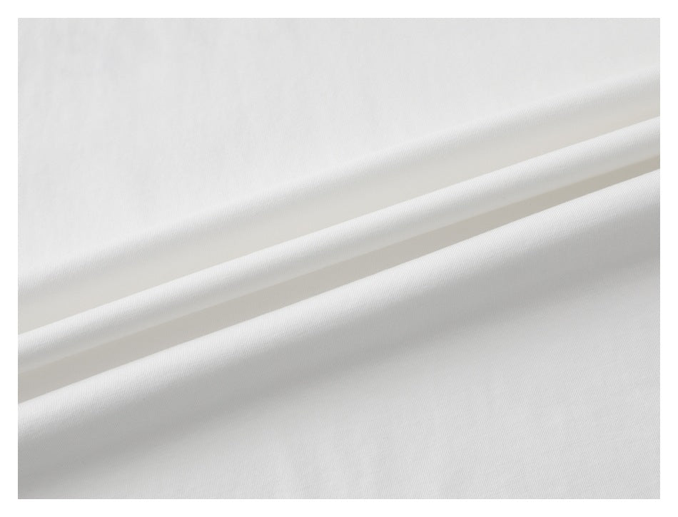 Close-up of white T-shirt fabric arranged in soft folds.