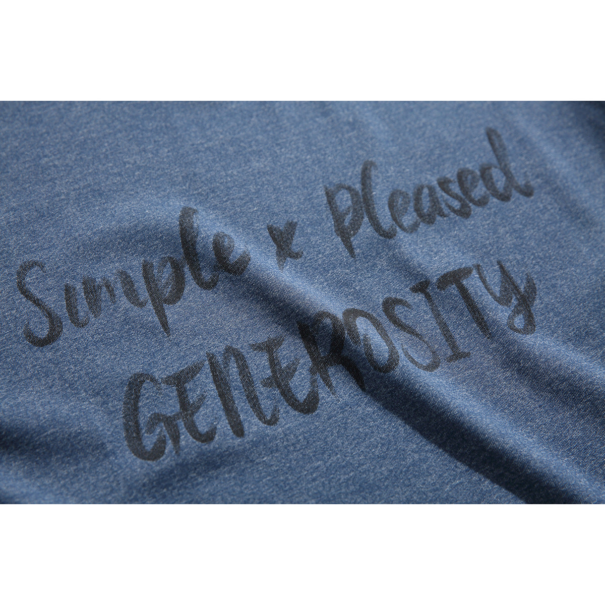 Close-up of dark English lettering printed on textured blue T-shirt fabric.