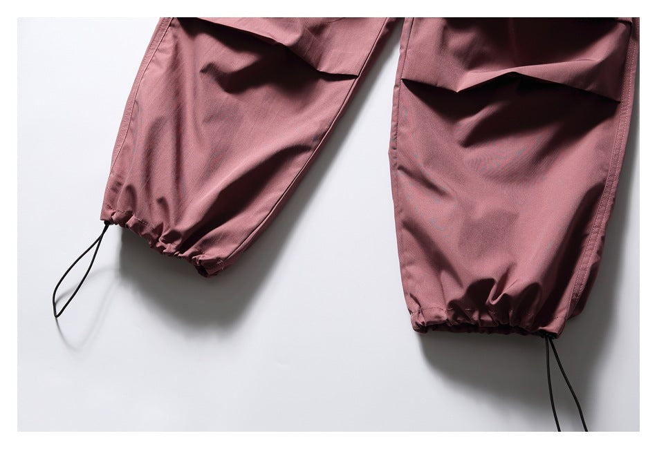 Close-up of dusty mauve trouser legs with gathered cuffs and black drawcords.