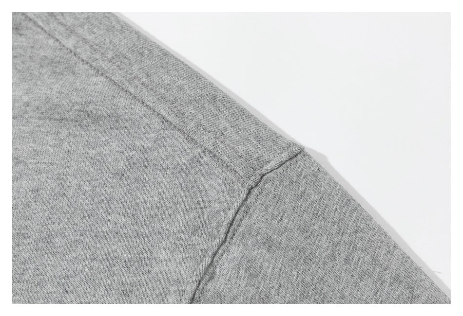 Close-up of the gray sweatshirt's shoulder and sleeve seam.