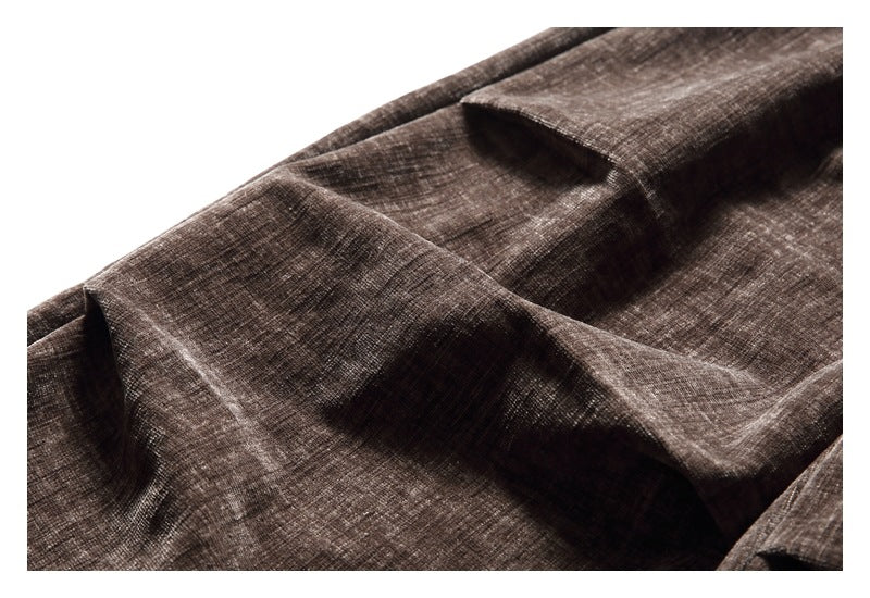 Close-up of brown crosshatched fabric gathered into soft folds.