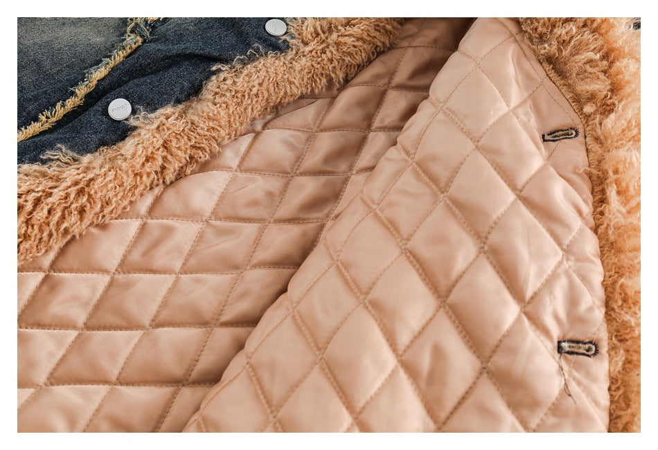 Close-up of a coat interior with pale blush diamond quilting, tan curly trim, and dark denim at the edge.