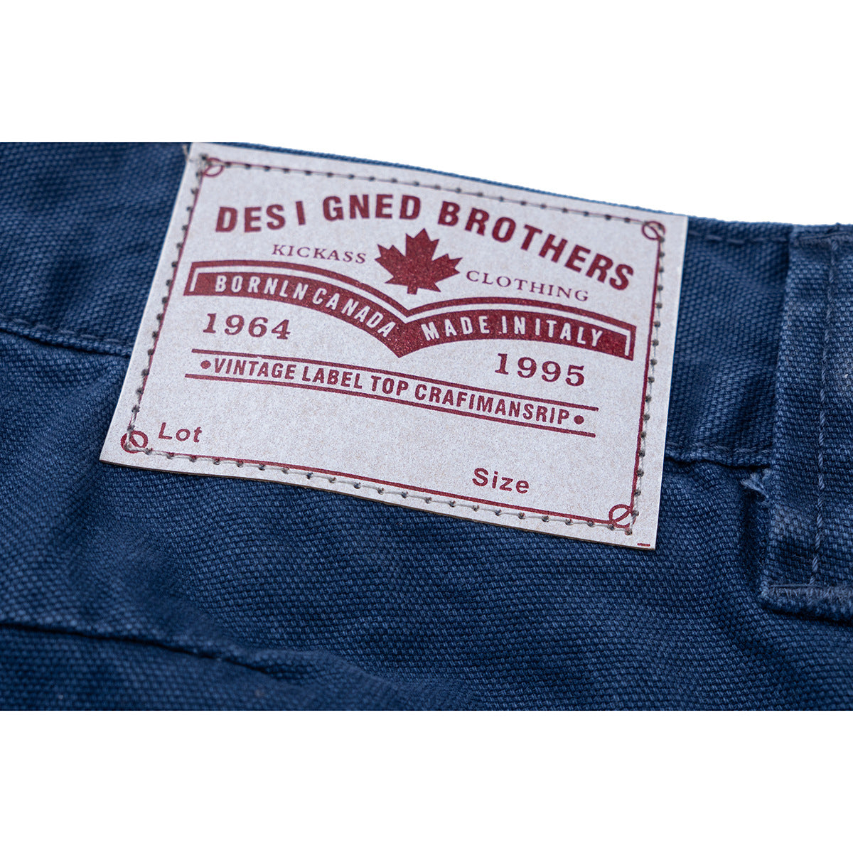 Close-up of a sewn English-language label on dark blue trousers.