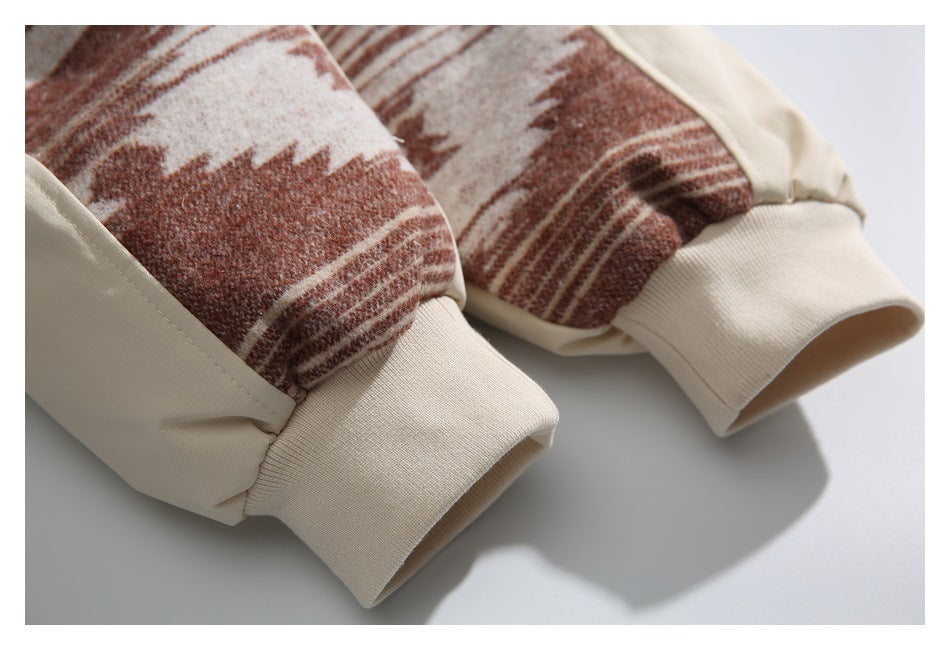 Close-up of two cream ribbed cuffs beside brown-and-cream patterned sleeve panels.