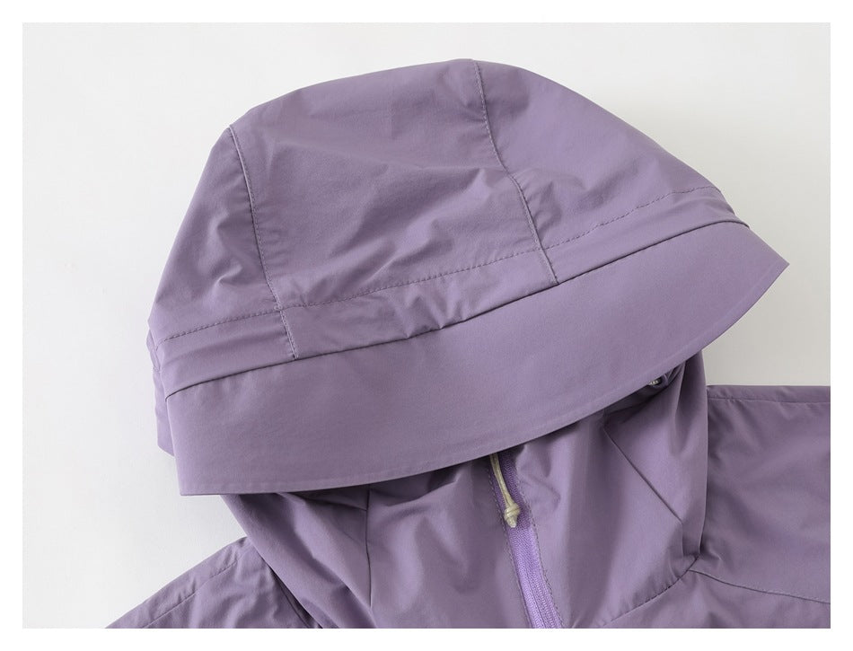 Close-up of a lavender jacket hood with panel seams and a wide brim.