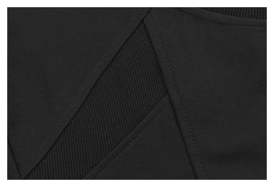 Close-up of a black T-shirt's ribbed inset panel and surrounding stitched seams.