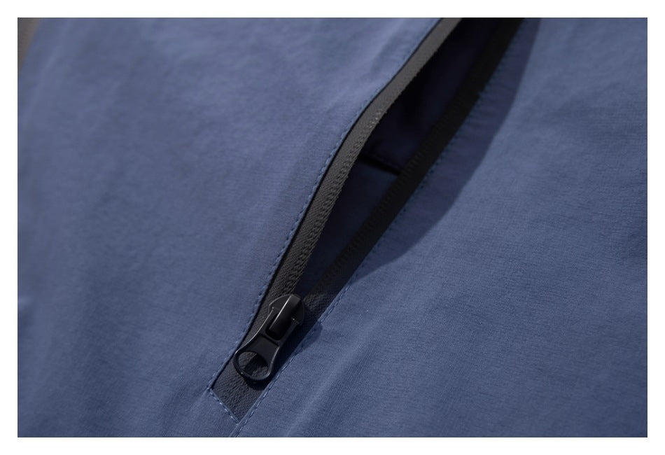 Close-up of the blue jacket's partially open dark front zipper.
