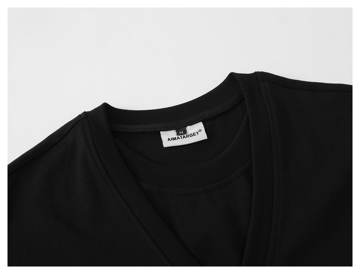 Close-up of a black shirt neckline and sewn-in AIMATARGET size M label.