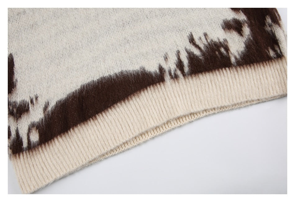 Close-up of a cream ribbed hem against a brown-and-cream patterned knit.