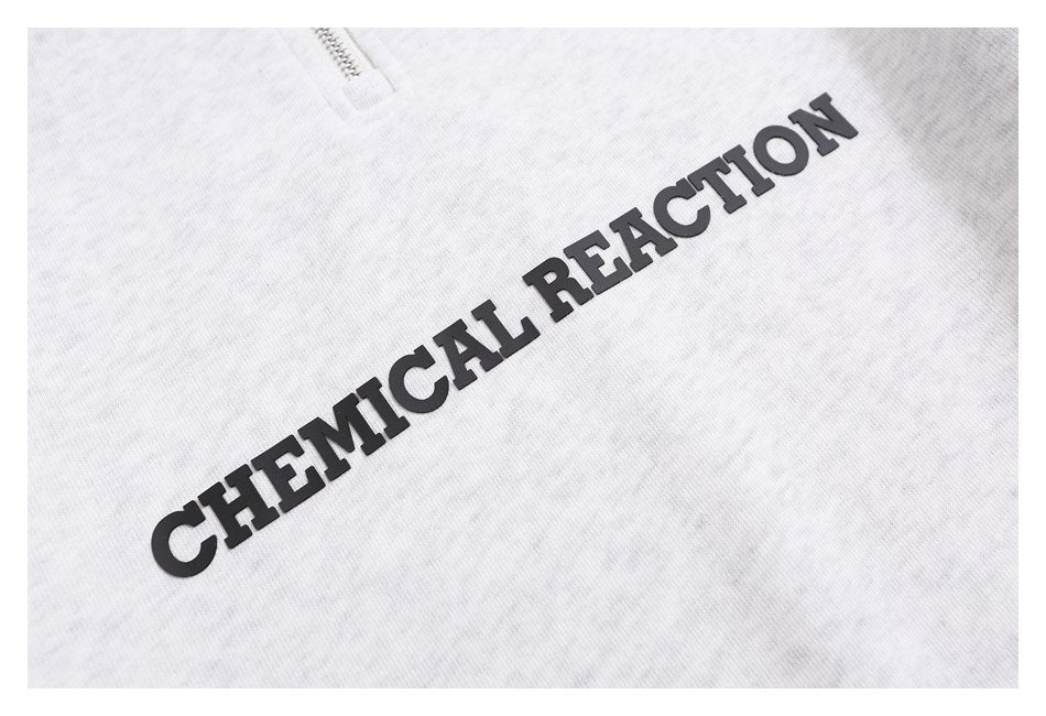 Close-up of raised black CHEMICAL REACTION lettering on light gray heathered fabric.