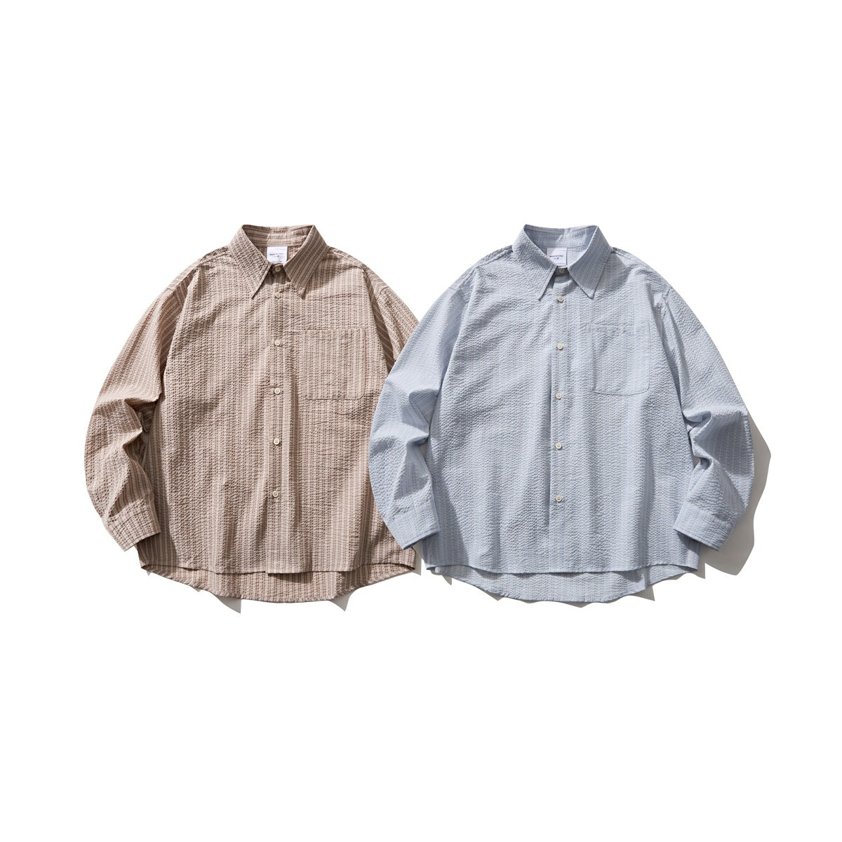 Two long-sleeve button-up shirts shown from the front: beige-brown patterned and light blue, each with a chest pocket.
