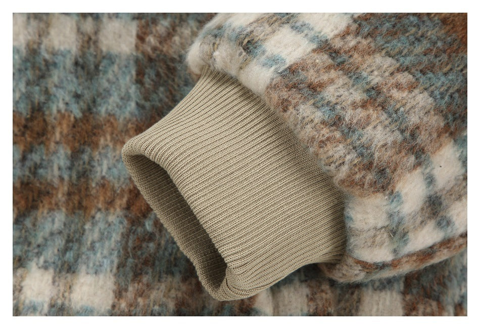 Close-up of a beige ribbed sleeve cuff against the jacket's fuzzy multicolor checked fabric.