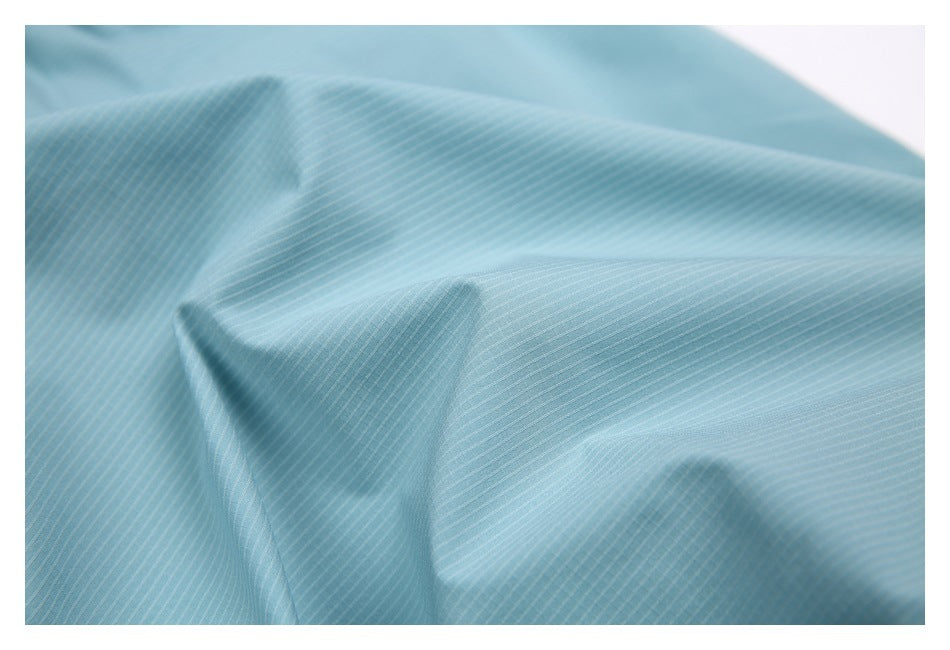 Macro view of pale aqua fabric with fine, closely spaced white pinstripes.