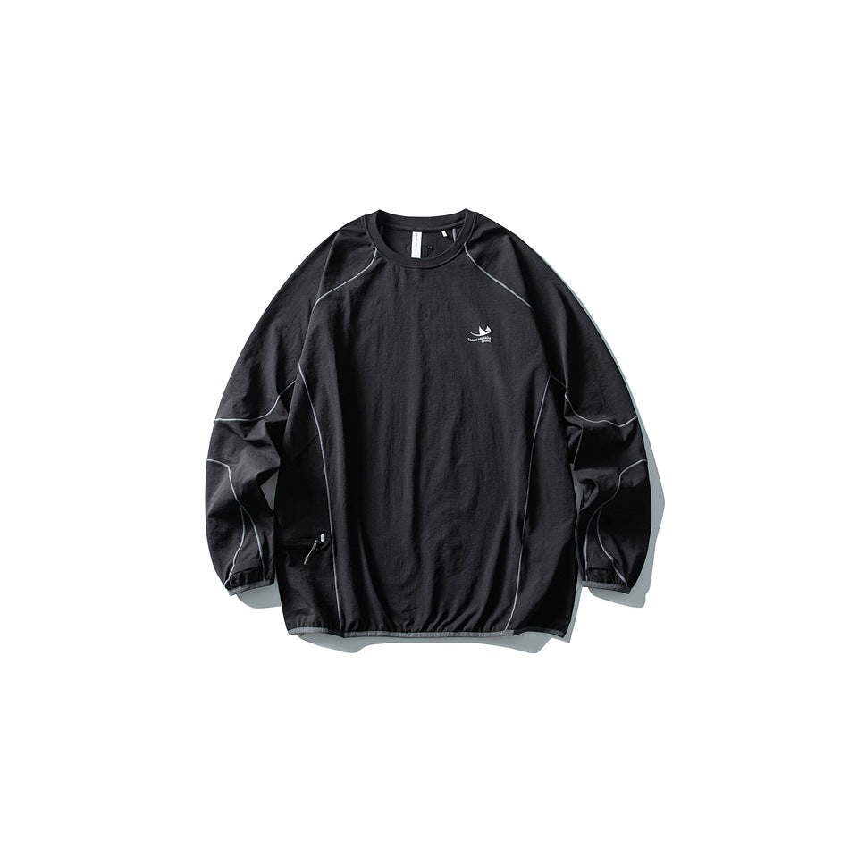 Black long-sleeve crew-neck top flat lay with gray contrast piping, zip pocket and gathered hem