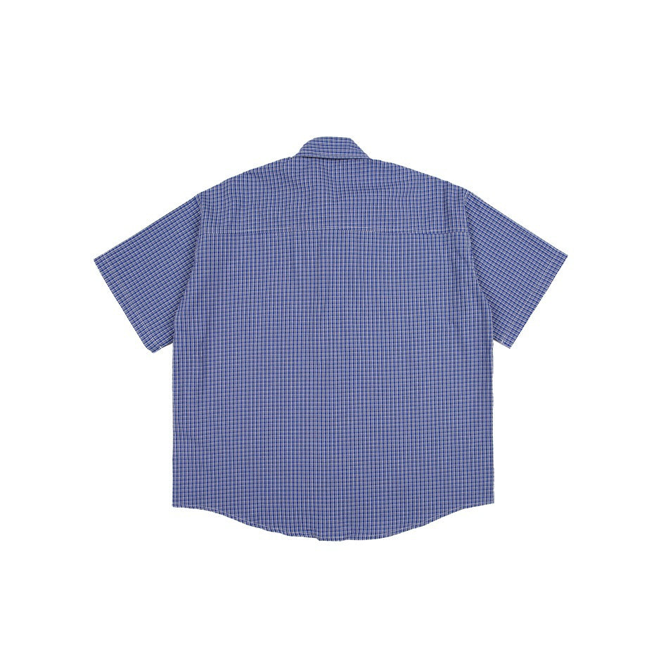 Back view of blue and white small plaid short-sleeve shirt flat lay showing back yoke seam