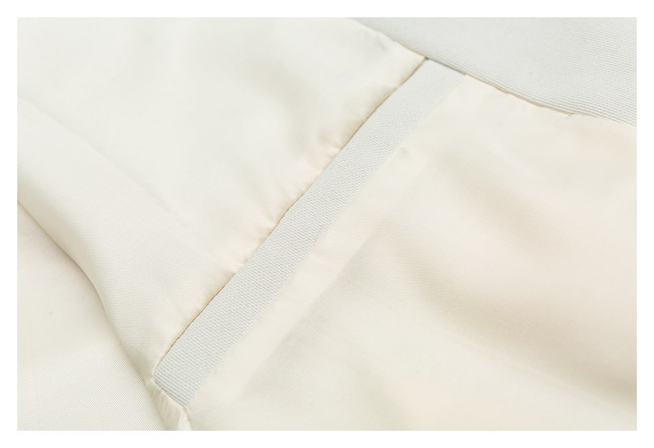 Close-up of an off-white garment's inner lining and seam tape.