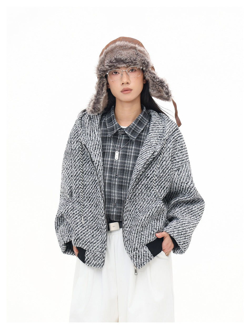 Model in the textured hooded jacket worn open over a plaid shirt, hands in pockets, with white pants