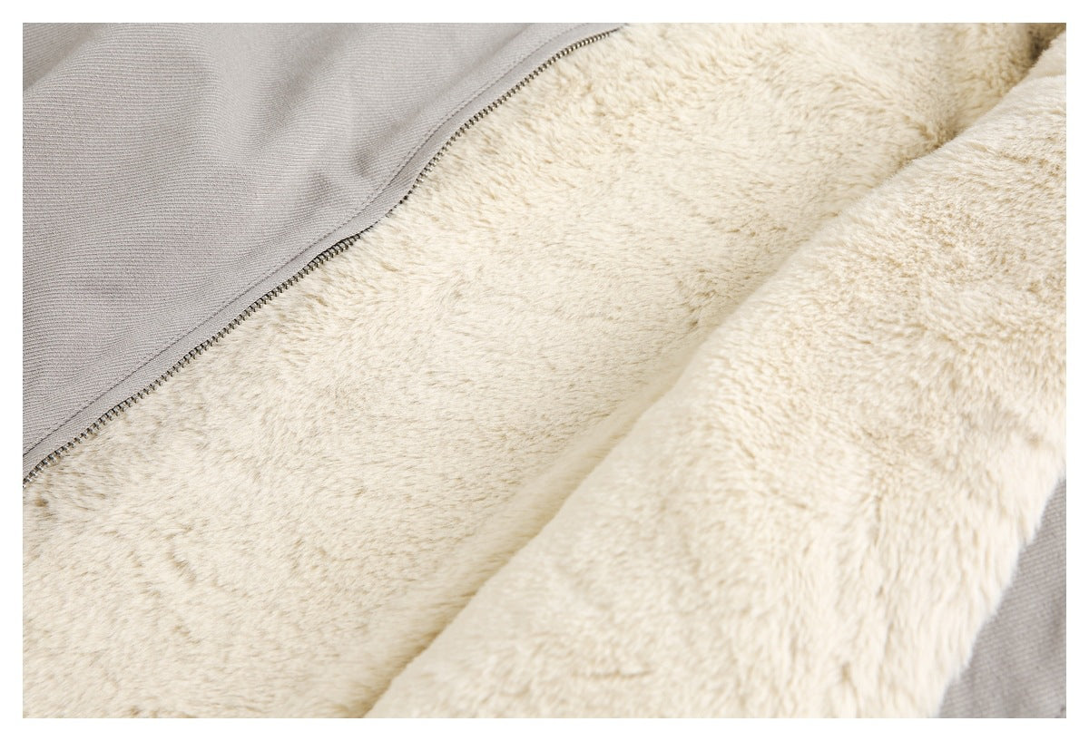 Close-up of cream plush lining and zipper inside a light taupe garment.