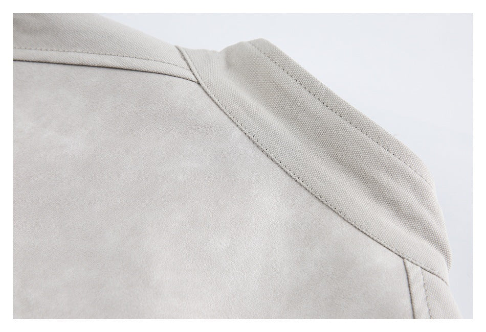 Close-up of a curved stitched panel seam on light gray fabric.