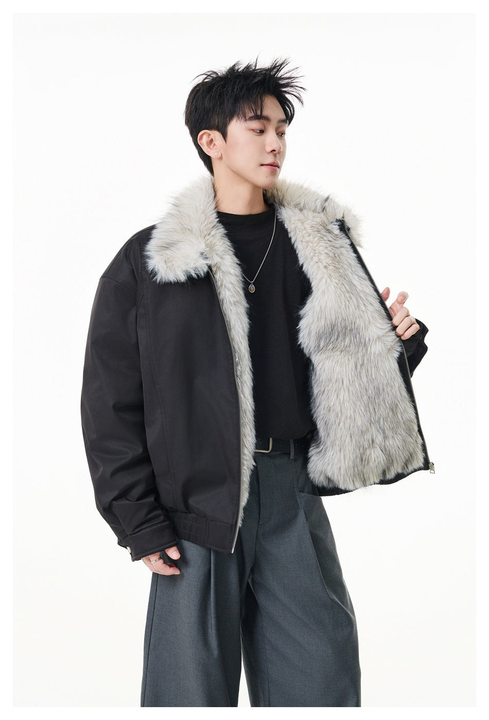 Model holds open a black jacket to show its light gray faux-fur collar and full lining.