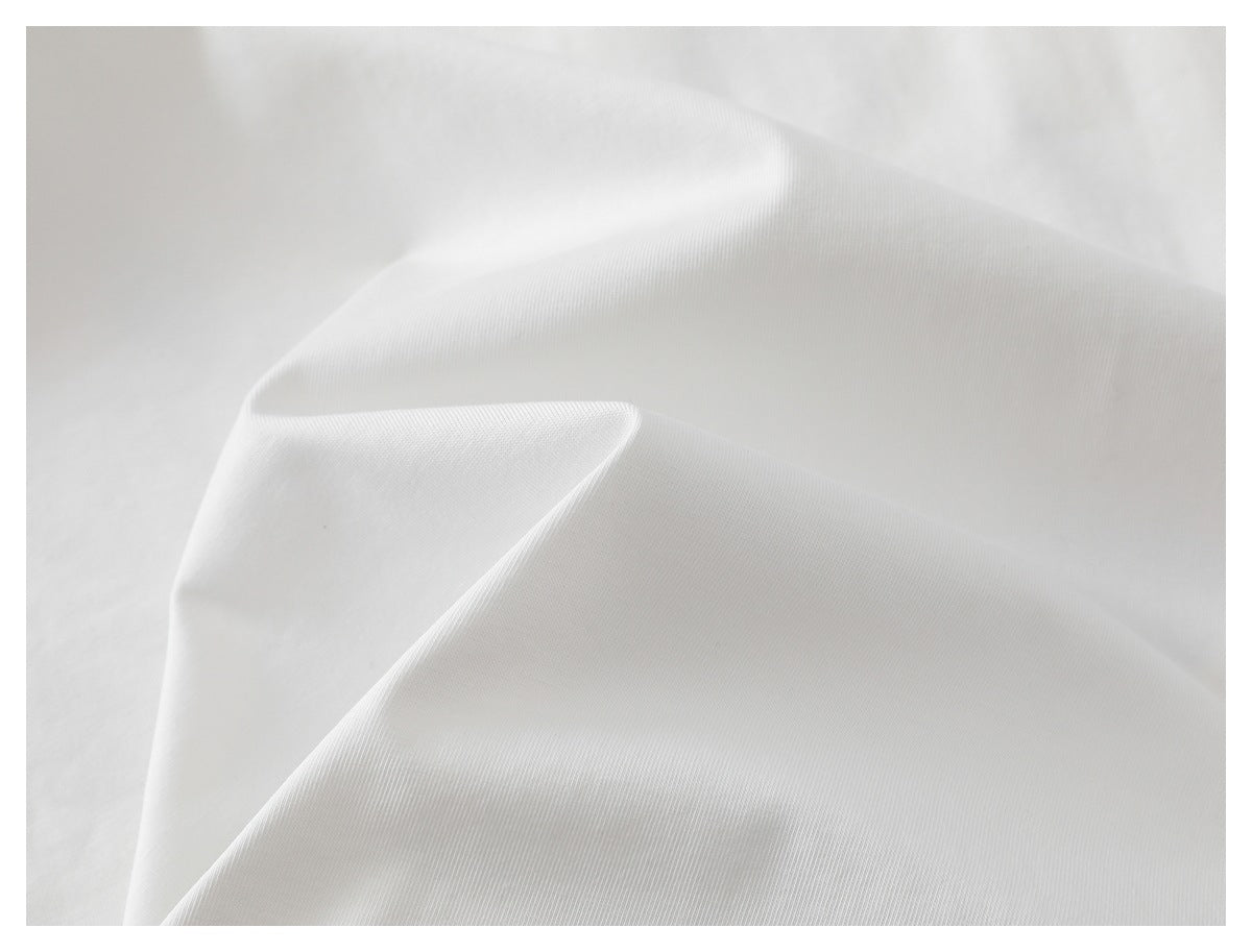 Close-up of white T-shirt fabric arranged in soft folds.