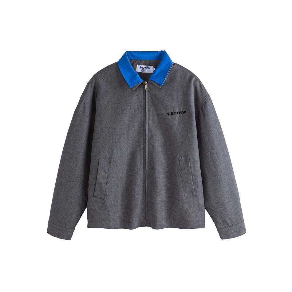 Gray zip-front jacket with bright blue collar, flap pockets and small embroidered chest lettering, flat front view