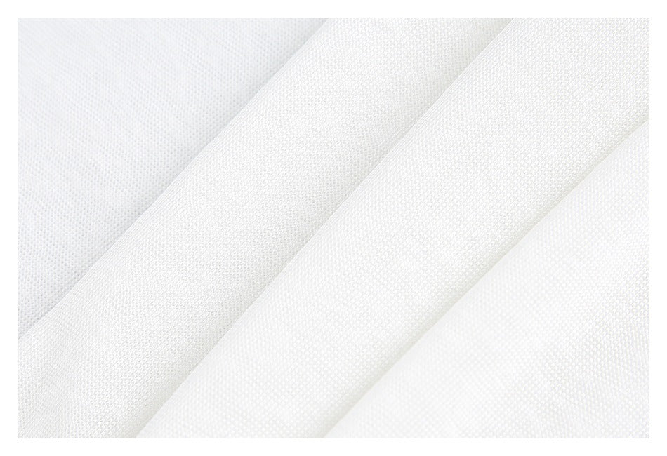 Macro view of white fabric showing its fine knit texture and folded layers.