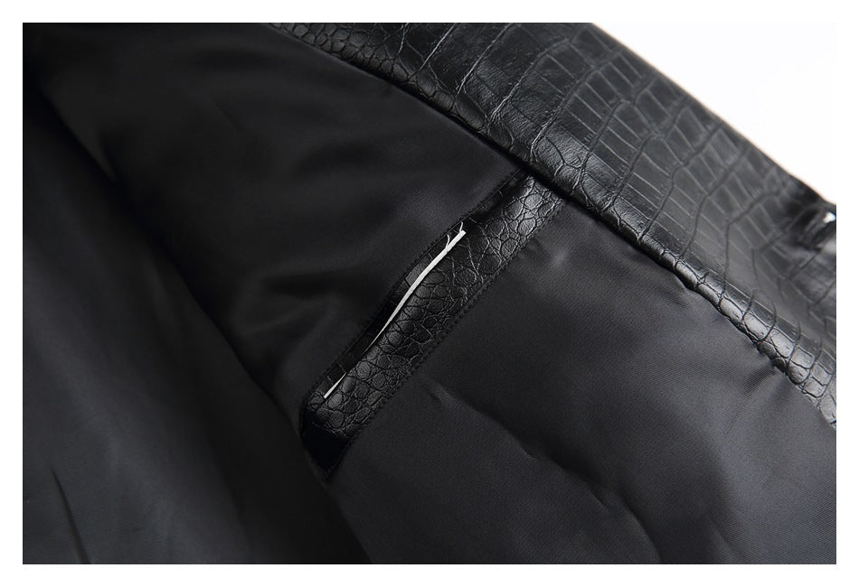 Close-up of the black lining and inner pocket opening beneath a crocodile-embossed outer panel.